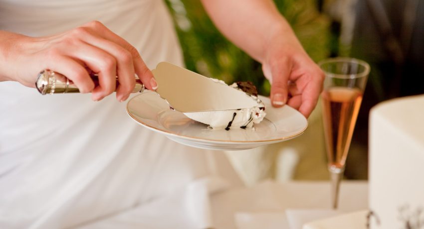 Bride-cutting-white-wedding-cake-on-fine-china-plate-175228341_3200x2133-2048x1365