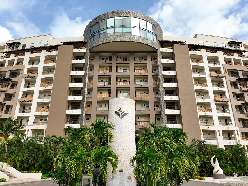Close-up of the main building entrance and resort logo monument