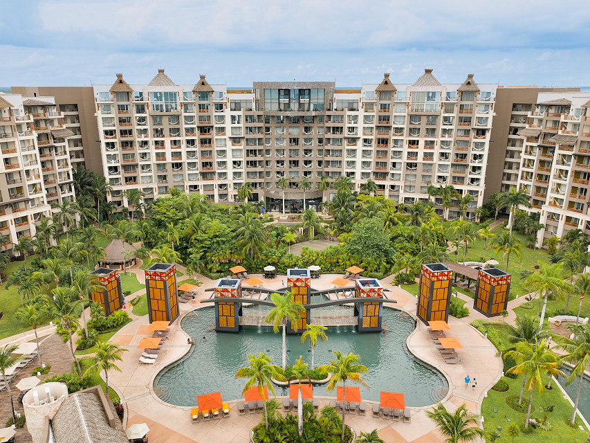 Wide aerial view of the resort complex, showing multi-story buildings surrounding a large