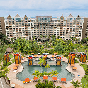 Wide aerial view of the resort complex, showing multi-story buildings surrounding a large
